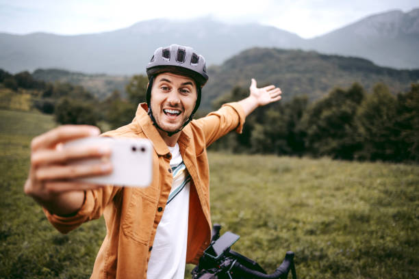 istock Handsome young cyclist taking a selfie in the mountain 1425688417