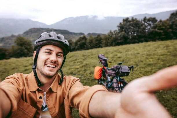 istock Handsome young cyclist taking a selfie in the mountain 1425688423