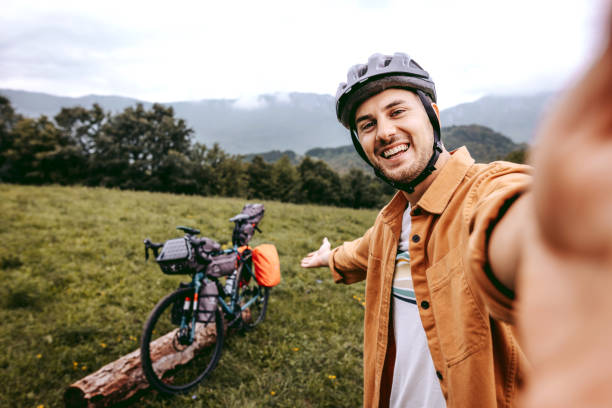 istock Handsome young cyclist taking a selfie in the mountain 1425688424