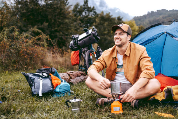 istock Young handsome hiker making coffee on a gas stove 1425688651