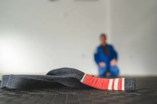 Brazilian jiu jitsu bjj black belt second degree on the tatami mats at gym or academy martial arts concept copy space selective focus