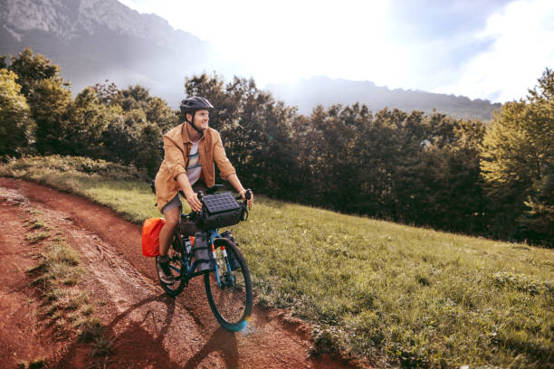Young casually clothed biker on a ride in a mountain