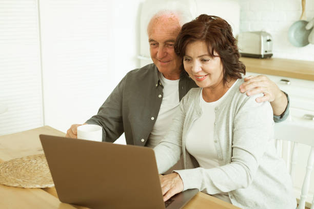 istock Elderly husband and wife using digital tablet at home, kitchen room 1425693206