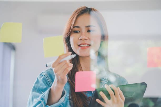 istock Web designers creating planning and analyzing with Colorful sticky notes on the office board.web design concept 1425697270