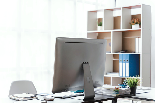 Stylish workspace with desktop computer and office supplies in business office.