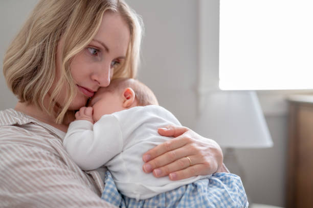 istock Loving Mom Holding Her Sleeping Baby 1425703890