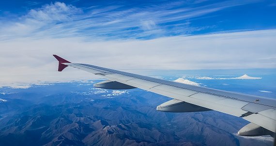 Flight on a plane, over the Andes - Chile, Pucon region. Mountains, snow and volcanos.