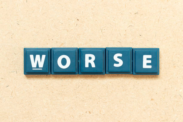 Tile alphabet letter in word worse on wood background