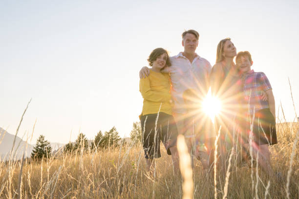istock Young family in mountain meadow at sunset 1425710196