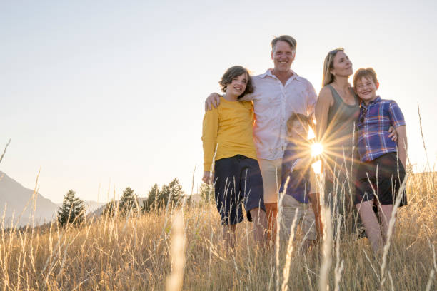 istock Young family in mountain meadow at sunset 1425710197
