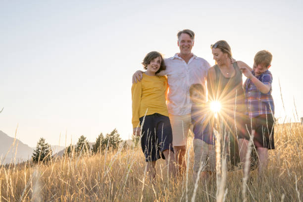 istock Young family in mountain meadow at sunset 1425710198