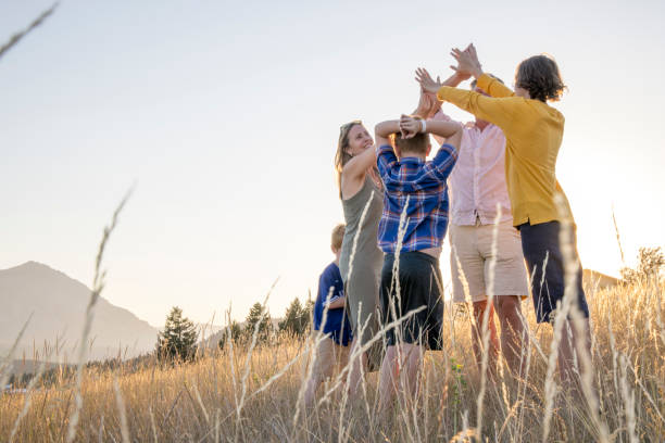 istock Young family in mountain meadow at sunset 1425710246