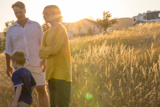 istock Young family in mountain meadow at sunset 1425710249