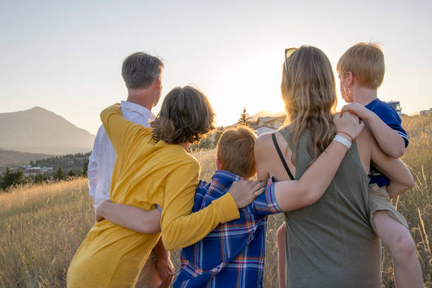 istock Young family in mountain meadow at sunset 1425710264