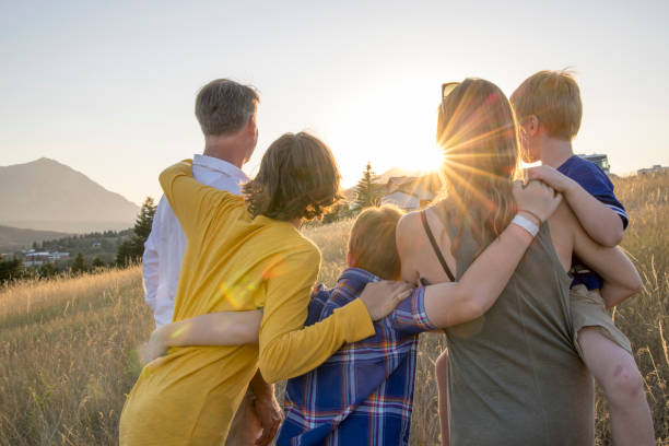 istock Young family in mountain meadow at sunset 1425710288