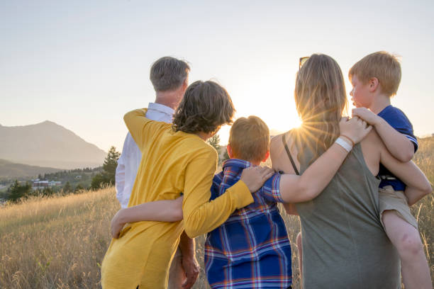 istock Young family in mountain meadow at sunset 1425710324
