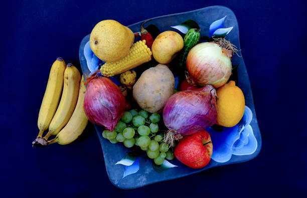 plato de frutas y verduras sobre fondo azul oscuro, alternativa a la dieta saludable. - multi well trays fotografías e imágenes de stock