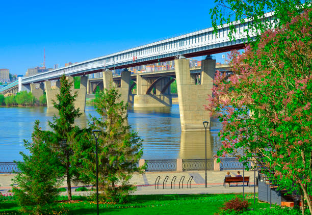 Novosibirsk, Siberia, Russia, 18.05.2022. Mikhailovskaya embankment on the Ob River. The world's largest metro bridge near the Gorsky district