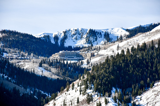 View of base village of Colorado, USA, ski resort on nice winter day; mountains and blue sky in background