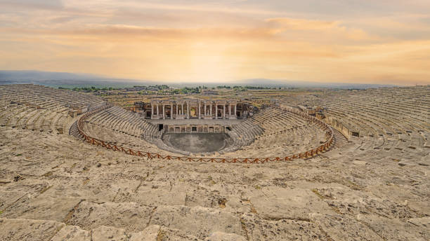 ampitheater at ruins ancient city Hierapolis in Pamukkale town, Turkey landscape scenery of ampitheater at ruins ancient city Hierapolis in Pamukkale town, Turkey arènes de fréjus photos stock pictures, royalty-free photos & images
