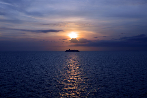 Cruising ocean liner on the ocean at sunset in the Caribbean Sea