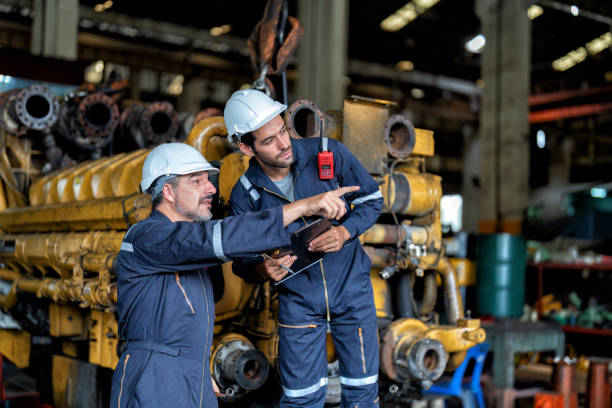 istock maintenance manager meet engineer checking and agreement hand check and sign on work schedule 1425722097