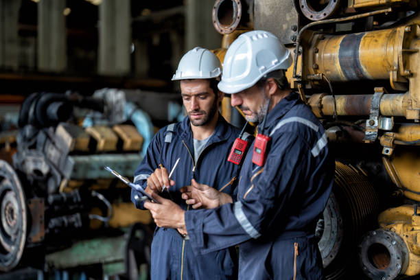 istock maintenance manager meet engineer checking and agreement hand check and sign on work schedule 1425722127
