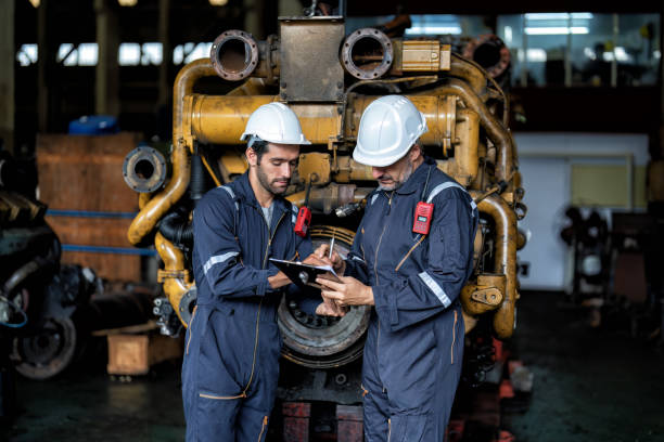 istock maintenance manager meet engineer checking and agreement hand check and sign on work schedule 1425722136