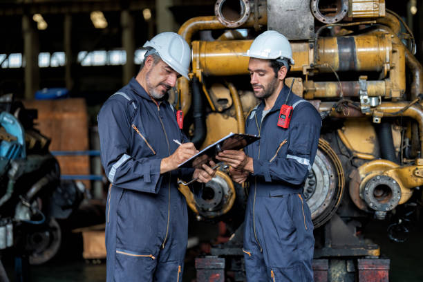 istock maintenance manager meet engineer checking and agreement hand check and sign on work schedule 1425722151