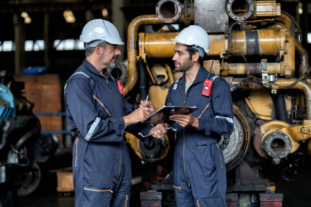 istock maintenance manager meet engineer checking and agreement hand check and sign on work schedule 1425722156