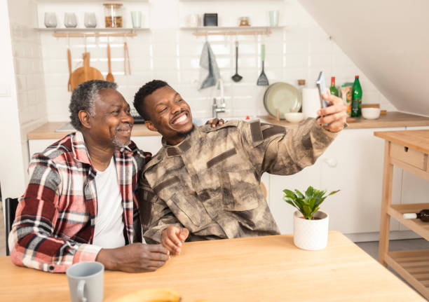 istock Young American soldier taking a selfie with his old father 1425726785