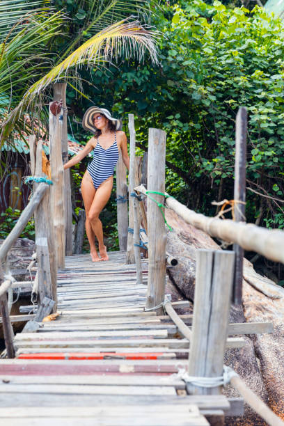 istock Woman posing on the beach stock 1425727577