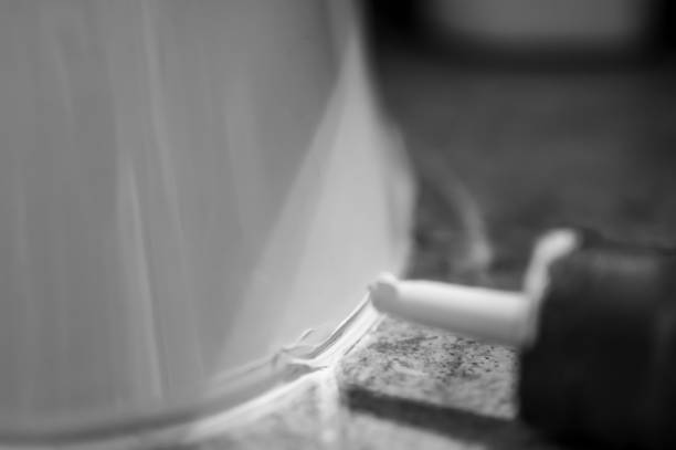 istock Selective focus on silicone caulking ready to be applied around the seal of a bathroom toilet. 1425733607