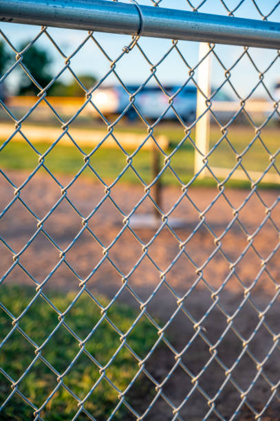 istock Focus on chain link fence with t-ball background 1425735069