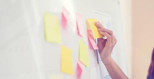 istock Business people meeting at office and use post it notes to share idea. Brainstorming concept. Sticky note on glass wall.business women working and communicating together in creative office 1425738939
