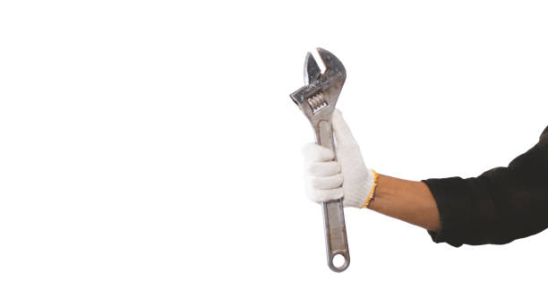 istock Male mechanic hands holding wrench in studio against white background 1425738985