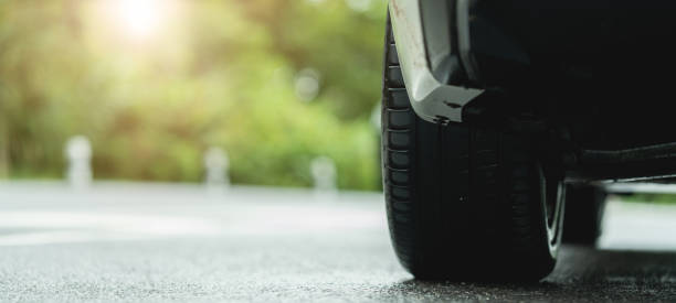 istock Behind a beautiful white car parked on a road with beautiful sunsets. with space for text. 1425739059