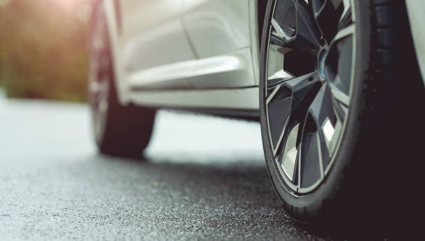 istock Behind a beautiful white car parked on a road with beautiful sunsets. with space for text. 1425739112