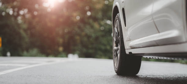 istock Behind a beautiful white car parked on a road with beautiful sunsets. with space for text. 1425739113
