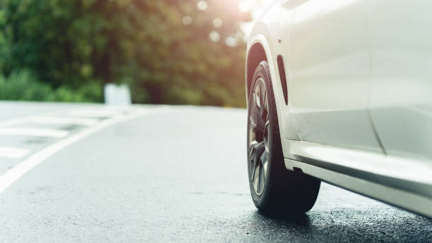istock Behind a beautiful white car parked on a road with beautiful sunsets. with space for text. 1425739114