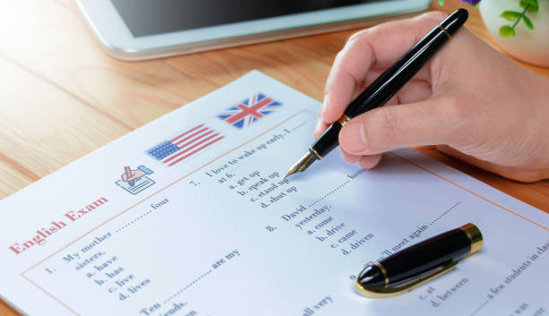 English test with pen on wooden table in class