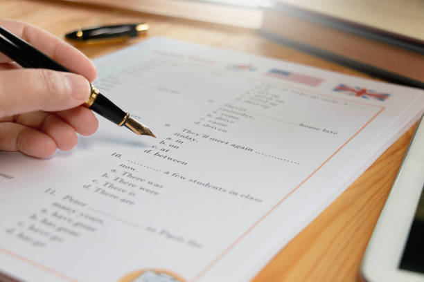 English test with pen on wooden table in class