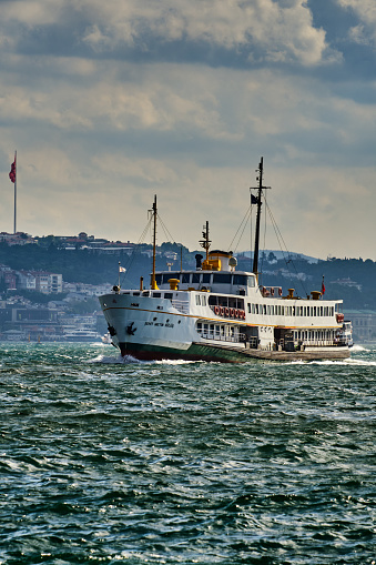 Istanbul, Turkey - July 18, 2022, Bosphorus, passenger ferry in Eminonu, view of the European part of the city , ferry swimming to the pier.