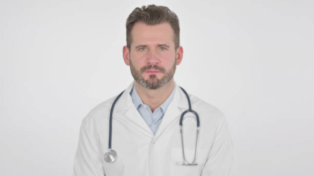 istock Middle Aged Doctor Showing Yes Sign by Head Shake, White Background 1425749883
