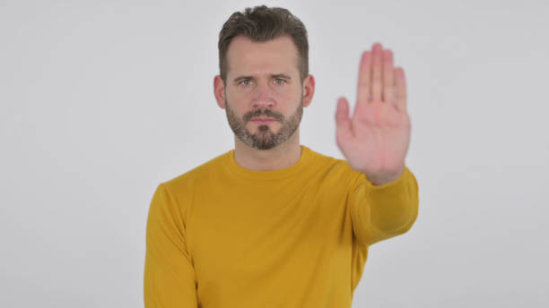 istock Middle Aged Man Showing Stop Sign by Hand , White Background 1425754066