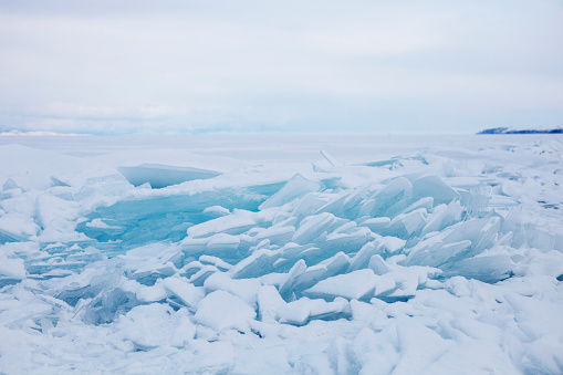 Turquoise ice floe. Winter landscape. Ice-drift of Baikal lake