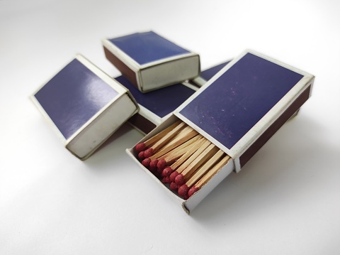 Wooden matches in a box isolated on a white blurred background