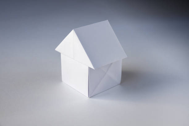istock Paper house origami isolated on a white background 1425762566