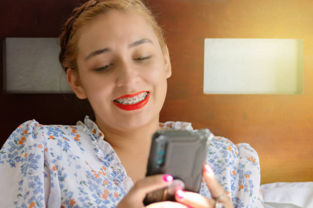 istock Hispanic young woman using cell phone, smiling relaxed 1425764775