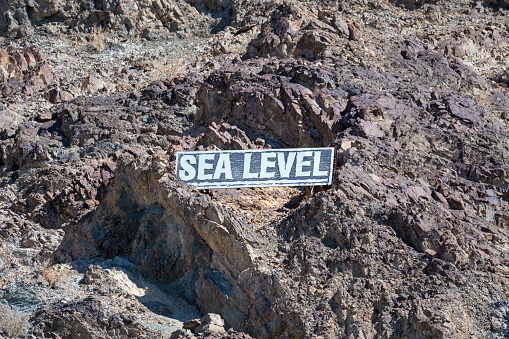 Sea level sign at the Badwater Basin at Death Valley National Park, California, USA. The lowest point on earth seen a hot summer day.